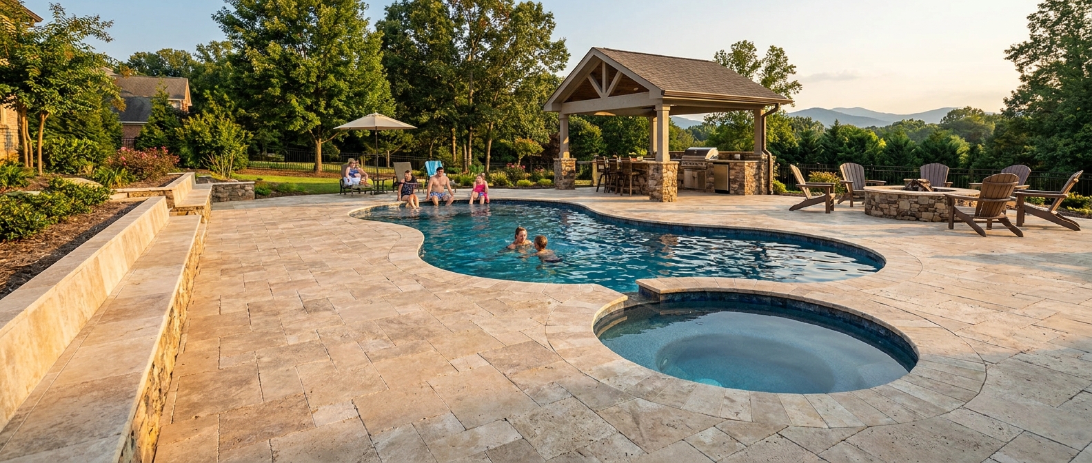 Luxury travertine pool surround with built-in seating wall and outdoor living area designed by Southern Pavers in Greer South Carolina